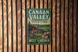 A vintage-style sign for Canaan Valley Resort State Park in West Virginia, featuring a scenic landscape with a cabin and flowers.