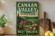 A vintage-style sign for Canaan Valley Resort State Park in West Virginia, featuring a scenic landscape with a cabin and pine trees.