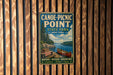 A vintage-style metal sign for Canoe-Picnic Point State Park in New York, featuring a scenic image of a lake, canoe, and picnic area.