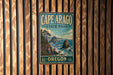 A vintage-style metal sign for Cape Arago State Park in Oregon, featuring a scenic landscape with mountains, trees, and the ocean.