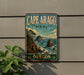 A vintage-style sign for Cape Arago State Park in Oregon, featuring a scenic landscape with mountains, cliffs, and the ocean.