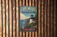 A vintage metal sign for Cape Meares State Scenic Viewpoint in Oregon, featuring a lighthouse and coastal landscape.