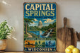 A vintage-style metal sign for the Capital Springs State Recreation Area in Wisconsin, featuring a scenic illustration of the state's natural beauty.