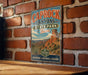 A vintage-style metal sign for Caprock Canyon State Park in Texas, featuring a scenic illustration of the canyon landscape.