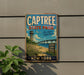 A vintage-style metal sign for Captree State Park in New York, featuring a scenic illustration of the park and a bridge.