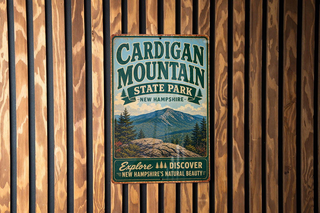 A vintage-style metal sign for Cardigan Mountain State Park in New Hampshire, featuring a scenic mountain landscape.