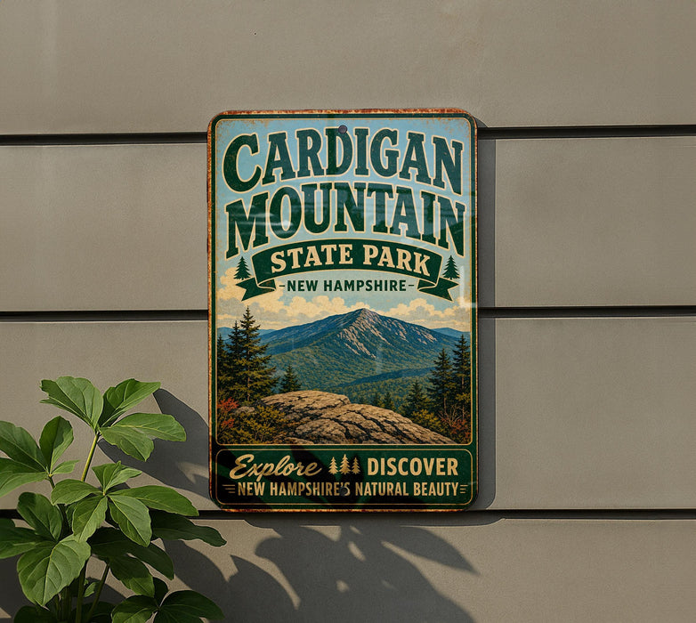 A vintage-style metal sign for Cardigan Mountain State Park in New Hampshire, featuring a scenic mountain landscape and the text "Explore, Discover, New Hampshire's Natural Beauty".