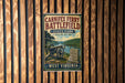 A vintage-style metal sign for Carniffex Ferry Battlefield State Park in West Virginia, featuring a cannon and a scenic landscape.