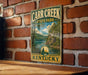 A vintage metal sign for Carr Creek State Park in Kentucky, featuring a scenic landscape with a lake and mountains.