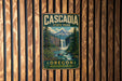 A vintage metal sign for Cascadia State Park in Oregon, featuring a waterfall and forest landscape.