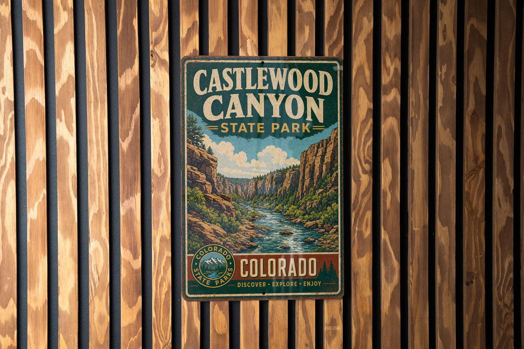 A vintage metal sign for Castlewood Canyon State Park in Colorado, featuring a scenic illustration of the canyon landscape.