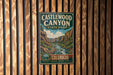 A vintage metal sign for Castlewood Canyon State Park in Colorado, featuring a scenic illustration of the canyon landscape.
