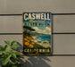 A vintage metal sign for Caswell Memorial State Park in California, featuring a scenic landscape with a coastal cliff, ocean, and trees.