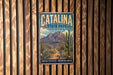 A vintage metal sign for Catalina State Park in Arizona, featuring a desert landscape with mountains, cacti, and a trail.