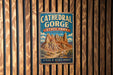 A vintage metal sign for Cathedral Gorge State Park in Nevada, featuring a scenic illustration of the canyon landscape.
