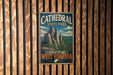 A vintage-style metal sign for Cathedral State Park in West Virginia, featuring a scenic illustration of the park's rock formations and mountains.