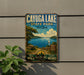 A vintage metal sign advertising Cayuga Lake State Park in New York, featuring a scenic image of the lake and surrounding landscape.