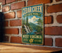 A vintage-style metal sign for Cedar Creek State Park in West Virginia, featuring a scenic illustration of a waterfall and forest.