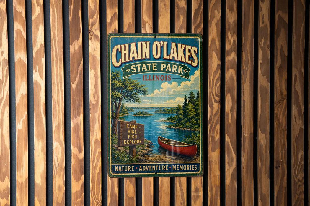 A vintage metal sign for Chain O'Lakes State Park in Illinois, featuring a scenic image of a lake, canoe, and forest.