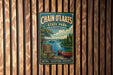 A vintage metal sign for Chain O'Lakes State Park in Illinois, featuring a scenic image of a lake, canoe, and forest.