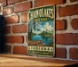 A vintage-style metal sign for Chain O Lakes State Park in Indiana, featuring a scenic landscape with a lake and trees.