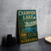 A vintage metal sign for Champion Lake, a state recreation area in Nebraska, featuring a scenic image of the lake and surrounding landscape.