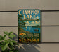 A vintage-style sign for Champion Lake, a state recreation area in Nebraska, featuring a scenic image of a lake with boats and a forest.
