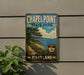 A vintage metal sign for Chapel Point State Park in Maryland, featuring a scenic image of a coastal landscape with a beach, trees, and a sailboat.
