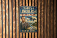 A vintage metal sign featuring a portrait of Charles A. Lindbergh, the famous aviator, and the text "State Park" and "The Spirit of Adventure Minnesota".
