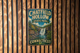 A vintage metal sign for Chatfield Hollow State Park in Connecticut, featuring a waterfall and lush greenery.