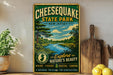 A vintage-style metal sign for Cheesecake State Park in New Jersey, featuring a scenic landscape with a river, trees, and mountains.