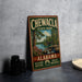 A vintage metal sign for Chewala State Park in Alabama, featuring a scenic landscape with a river, bridge, and trees.