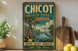 A vintage-style sign for Chicot State Park in Louisiana, featuring a serene image of a bird standing in a pond surrounded by lush greenery.