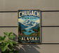 A vintage metal sign for Chugach State Park in Alaska, featuring a scenic mountain landscape with a moose and pine trees.