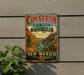 A vintage-style metal sign for Cimarro Canyon State Park in New Mexico, featuring a scenic landscape with mountains, a river, and a desert backdrop.