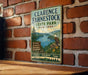 A vintage-style metal sign for Clarence Fahnstock State Park in New York, featuring a scenic image of the park and a bird of prey.
