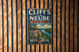 A vintage metal sign for Cliffs of the Neuse State Park in North Carolina, featuring a scenic illustration of a cliff overlooking a river.