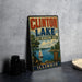 A vintage metal sign for Clinton Lake, Illinois, featuring a sailboat on the lake and a scenic landscape.