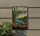 A vintage metal sign for Clough State Park in New Hampshire, featuring a scenic landscape with pine trees, a lake, and mountains.
