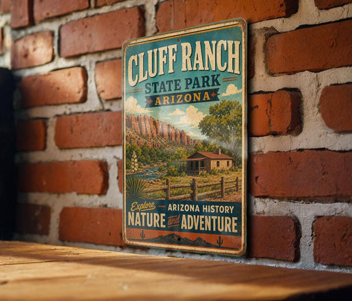 A vintage-style metal sign for Cluff Ranch State Park in Arizona, featuring a scenic landscape with mountains, a cabin, and a river.