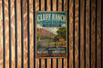 A vintage metal sign for Cluff Ranch State Park in Arizona, featuring a scenic illustration of the park's landscape and a cabin.