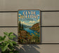 A vintage metal sign for Clyde Holliday State Recreation Site, featuring a scenic landscape with a river, mountains, and flowers.
