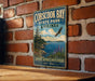 A vintage metal sign for Cobscook Bay State Park in Maine, featuring a scenic landscape with a bird in flight, a pine tree, and a body of water.
