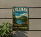 A vintage-style metal sign for Coleman State Park in New Hampshire, featuring a scenic landscape with pine trees, a lake, and mountains.