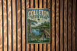 A vintage-style metal sign for Colleton State Park in South Carolina, featuring a scenic landscape with a river, palm trees, and a wooden bridge.