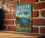 A vintage metal sign for Collier Memorial State Park in Oregon, featuring a scenic landscape with mountains, a lake, and pine trees.