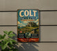A vintage metal sign for Colt State Park in Rhode Island, featuring a scenic illustration of a house, a lighthouse, and a ship on the ocean.