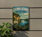 A vintage-style metal sign for Columbus-Belmont State Park, featuring a scenic image of a river and cliffs, is displayed on a wall next to a plant.