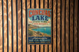 A vintage metal sign for Conchas Lake State Park in New Mexico, featuring a scenic image of the lake and mountains.