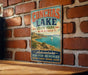 A vintage-style sign for Conchas Lake State Park in New Mexico, featuring a scenic image of the lake and mountains.